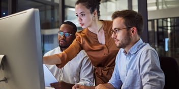 IT team group of three looking at monitor IT service provider