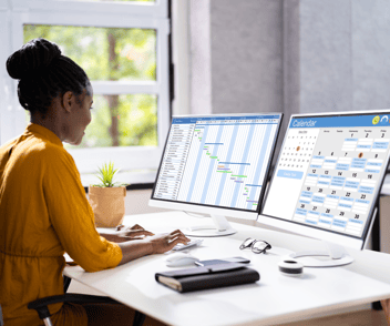 professional-woman-typing-on-computer-using-spreadsheets
