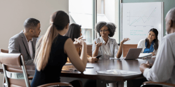 group of people meeting around a table 