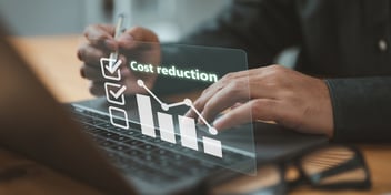 Businessman lowering the arrow of a graph, concept of cost reduction